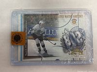 Front of Wayne Gretzky Upper Deck Authenticated limited print hockey card in protective case showing player image and serial number 07680/10000