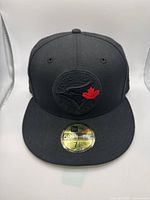 Front view of the New Era black 59FIFTY fitted hat with Toronto Blue Jays logo and size sticker.