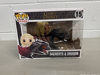 Front view of the boxed Funko Pop Rides Daenerys & Drogon figure showing the figures through the clear plastic window and Game of Thrones and Pop Rides logos.