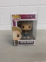 Front view of the Justin Bieber Pop Funko Rocks vinyl figure in original packaging showing the figure and package details.