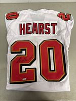White San Francisco 49ers football jersey with number 20 and 'HEARST' name on the back, showing signature on number 20.