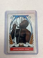 Front side of signed Topps WWE Heritage wrestling card featuring Junkyard Dog with autograph visible on clear protective sleeve.