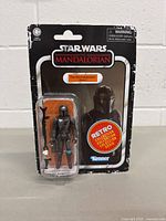Front view of Star Wars The Mandalorian action figure in original Retro Collection packaging, showing the figure and accessories clearly.