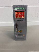 Front side of sealed gray locker-style box with Upper Deck Locker Series logo and text mentioning six collectible boxes featuring Michael Jordan.