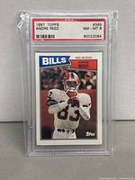 Front side of 1987 Topps Andre Reed graded football card in PSA case