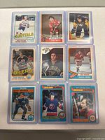 Nine vintage hockey cards arranged in 3x3 grid, showing front images and identifying players and teams.