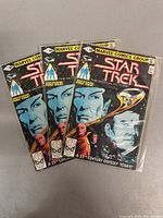 Three copies of Marvel Comics Group Star Trek The Motion Picture issue #1 comics stacked together, sealed in plastic, showing front covers.