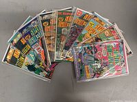 Lot of 9 vintage DC Superboy comic books, fanned out showing various cover arts and titles