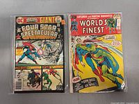 Two vintage DC comic books in plastic sleeves. One is Four Star Spectacular Giant with Superman on the cover. The other is World's Finest issue #212 with Superman and Martian Manhunter.
