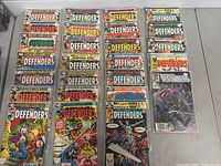 Photo showing all comics laid out in rows, featuring colorful vintage covers with Marvel Comics Group logo and The Defenders title.