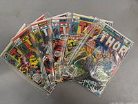 Lot of 6 vintage Marvel Comics 'The Mighty Thor' comic books laid out in protective sleeves.