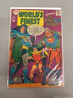 Front cover featuring Batman, Robin, Superman in costume, colorful vintage comic art, minor crease and edge wear visible.