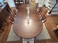 Overhead view of table set with glassware, showing table top surface, finish and chair arrangement.