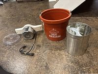 complete disassembled ice cream maker components on surface