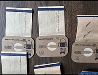 Three Electrolux Multi Filter vacuum bags laid flat showing collar and blue-strap closure