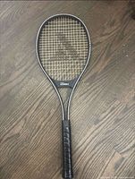 Full view of Pro Kennex tennis racquet showing frame, strings, grip