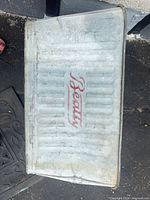 Top view showing ribbed galvanized lid/base with red "Beauty" branding
