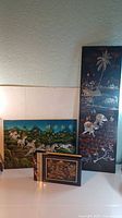 Photo of two Asian art panels and the musical scrapbook arranged together