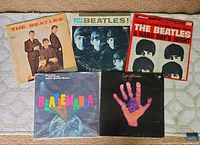 Top view of all five vinyl record albums on a carpeted surface, showing all cover artwork and titles.