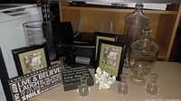Wide view of assortment including frames, glass canisters, paperweight, and metal mailbox