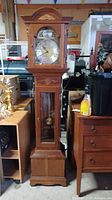 Full view of the cherry wood grandmother longcase clock.