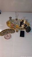 Overview of entire lot showing the gold tray, perfume bottles, lipstick holder, ring holder, and ornate container