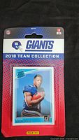 Front view of sealed 2018 Donruss NY Giants team card set packaging showing player card visible through plastic.