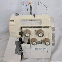 Front view of Bernina Bernette 335S serger sewing machine showing control dials and front panel.