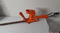 Side view of the Black & Decker electric hedge trimmer showing the full 13 inch cutting blade and body with handle.