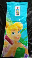 Towel showing detailed Tinkerbell image against blue background with original tag attached.