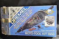 Photo of the original blue Dremel 3950 Moto-Tool box showing product info and multi-use claims.