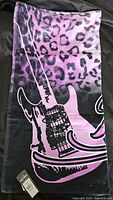 Purple leopard print towel with a large guitar design and Hard Rock Cafe logo