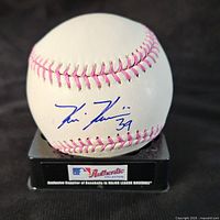 View of the baseball showing the blue ink autograph by Kevin Kiermaier, number 39, resting on a black stand with MLB Authentic Collection branding.