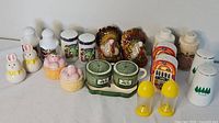 Full lot of ten assorted salt and pepper shaker sets including rabbits, pigs, turkeys, green ceramic set, and others.