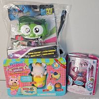 Photo showing Teen Titans GO! Beast Boy figure, Squishmallow Bentos, and Pretty Petz toy in original packaging.