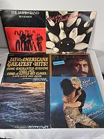 Six vinyl records including The Edgar Winters Band, J. Geils Band, Jay and the Americans, Jim Croce, Rod Stewart, and Santana.
