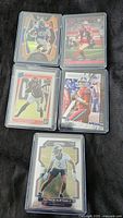 Front side of five football trading cards showing players in action or portrait.