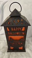 Front and side view of black metal Halloween lantern with 'Happy Halloween' and cat cut-out design