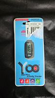Front view of YOO Mini Plus R2 Activity Tracker in sealed blue packaging showing product image and details.