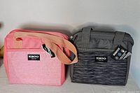 Front view of pink and dark gray Igloo cooler bags showing logo and handle details