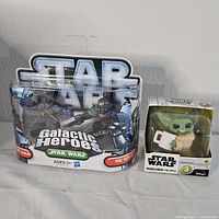 Photo showing Star Wars Galactic Heroes 3-pack and Mandalorian The Child figure new in packaging.