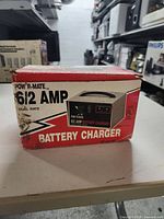Original product box showing Pow-R-Mate 6/2 AMP dual rate battery charger label and illustration.