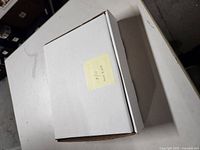 Closed white box labeled '9/11, Sept 11 01' on a post-it note