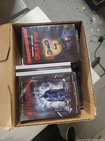 Top view of box showing DVDs including Child's Play and Mirrors