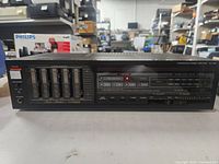 Front view of Fisher CA-260 integrated stereo amplifier showing power switch, speaker selector, headphone jack, and 5-band graphic equalizer sliders.