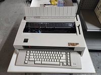 Full view of the IBM Wheelwriter 3 electric typewriter showing keyboard, paper feed, and roller platen.