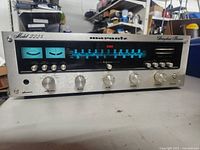 Front view showing illuminated tuning dial, signal meters and all front controls