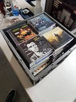 Top view of crate showing four CDs on top layer: Insane Clown Posse, A Perfect Circle, Peter Gabriel, Gladiator soundtrack