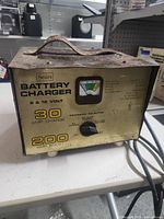Front view of Sears battery charger showing charging selector, analog meter, and 30 amp 6 & 12 volt capability markings