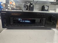 Front view of Sony A/V Control Center showing label, controls, and digital tuner display.